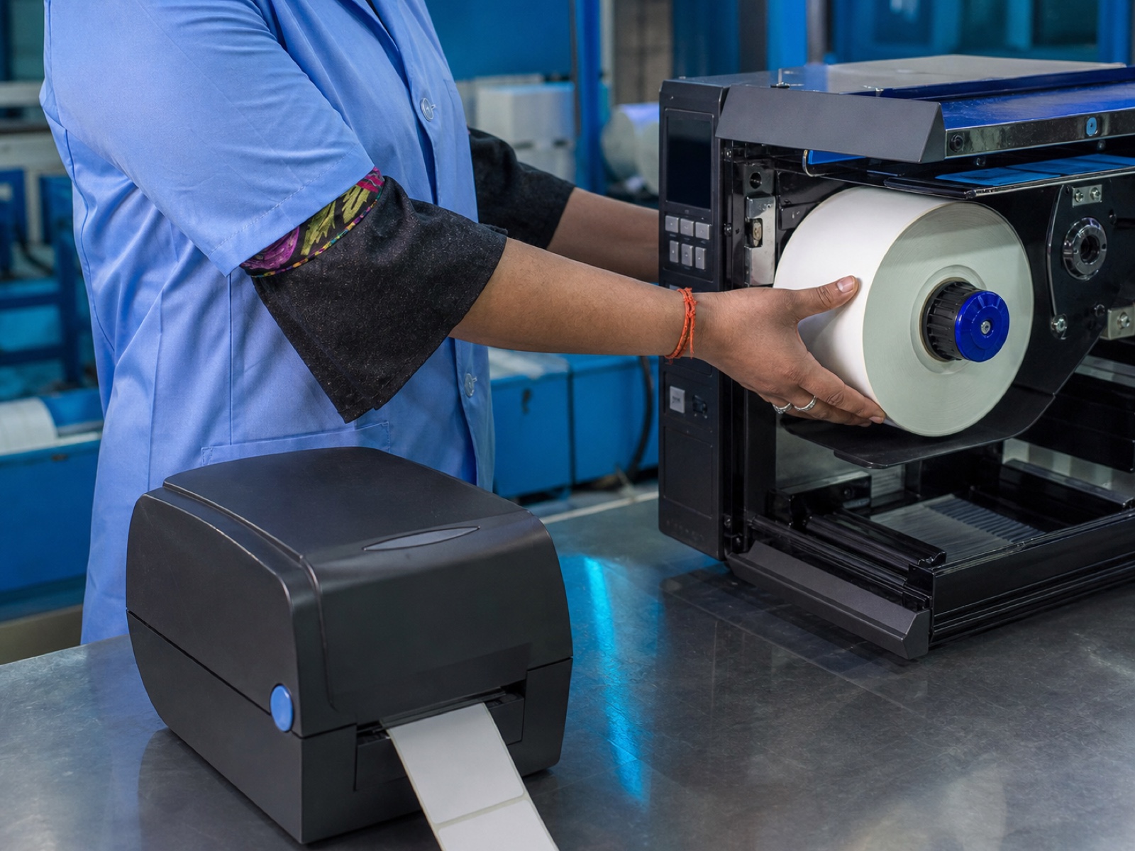 A desktop label printer and an industrial label printer with a roll being loaded